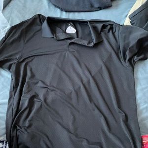 black golf shirt. says adams golf on the sleeve